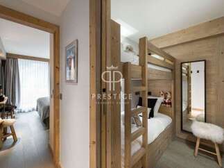 Discover the charm of this cozy bedroom, featuring a unique bunk bed design perfect for families or guests.