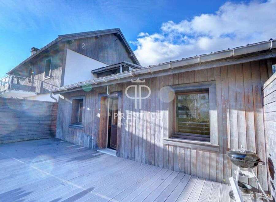 Discover a charming wooden house with a cozy outdoor space.