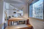 Discover a charming property with a cozy dining area, featuring a wooden table and bench.
