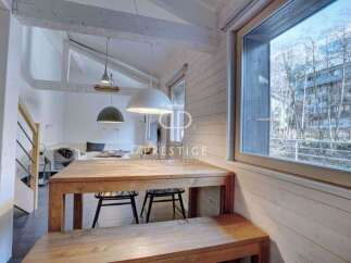 Discover a charming property with a cozy dining area, featuring a wooden table and bench.