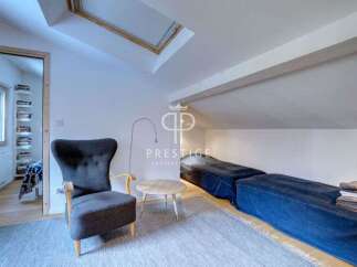 Discover this charming property featuring a cozy seating area with a stylish armchair and a small round table.