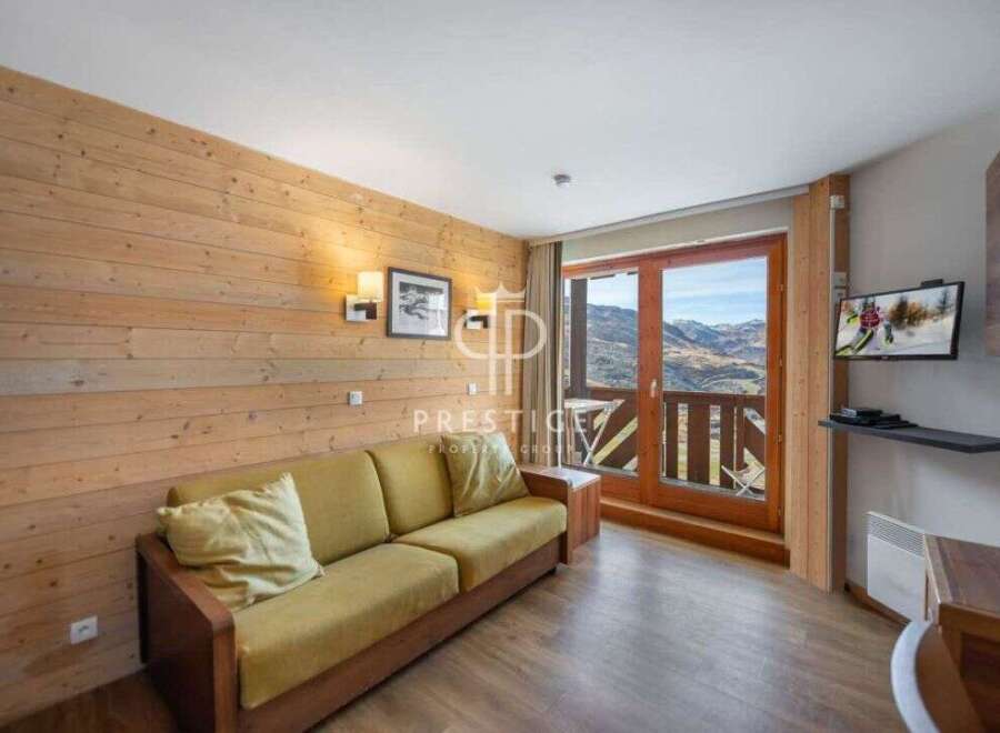 Cozy mountain retreat with stunning views! This charming property features a comfortable sofa, perfect for relaxing after a day on the slopes.