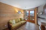 Cozy mountain retreat with stunning views! This charming property features a comfortable sofa, perfect for relaxing after a day on the slopes.