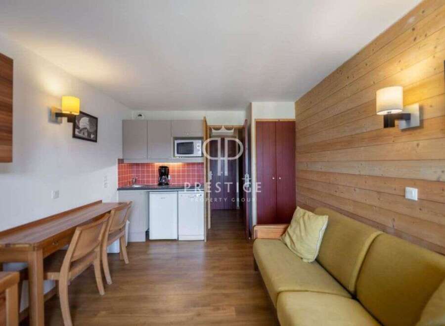 Discover a cozy apartment featuring a well-equipped kitchen with a microwave and refrigerator.