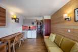 Discover a cozy apartment featuring a well-equipped kitchen with a microwave and refrigerator.
