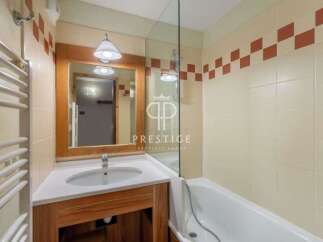 Discover a stylish bathroom featuring a sleek vanity and a modern shower enclosure.