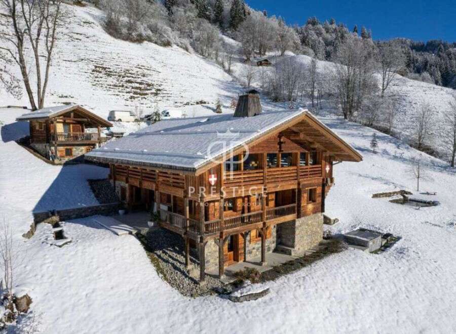 Discover a stunning chalet nestled in a snowy mountain landscape.