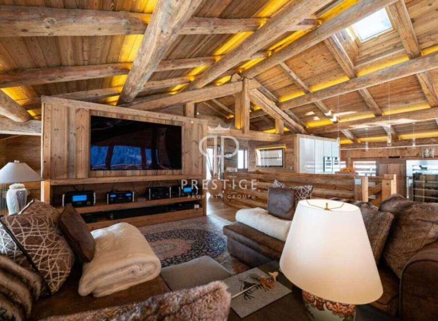 Experience luxury living in this stunning property, showcasing exquisite wooden architecture and a cozy ambiance.