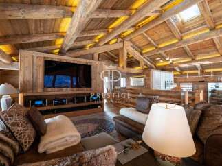 Experience luxury living in this stunning property, showcasing exquisite wooden architecture and a cozy ambiance.