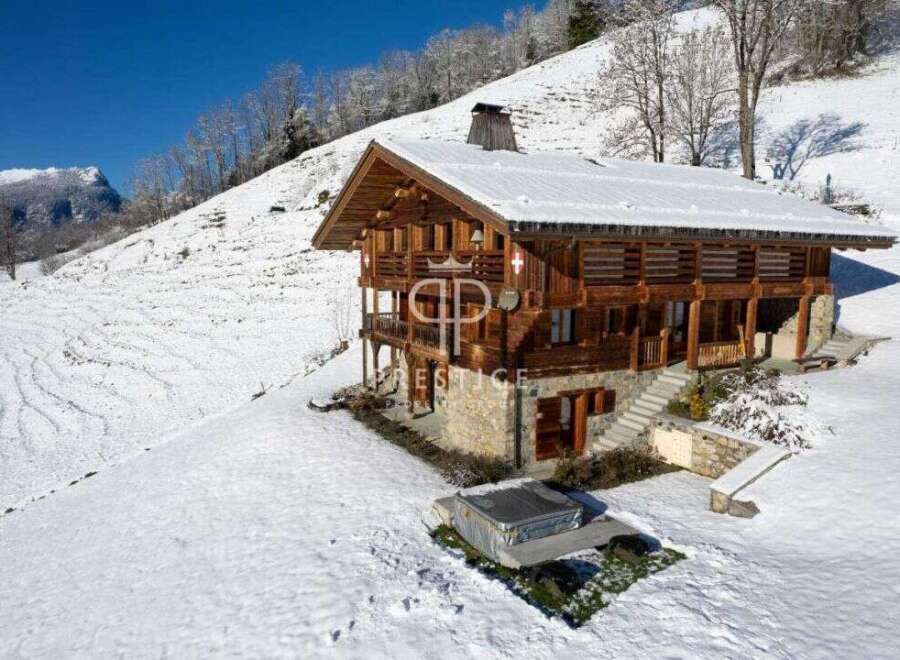 Discover a stunning chalet nestled in a snowy mountain landscape.