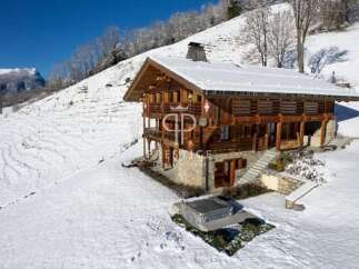 Discover a stunning chalet nestled in a snowy mountain landscape.