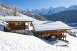 Experience the ultimate alpine escape in this stunning chalet nestled amidst a snowy landscape.