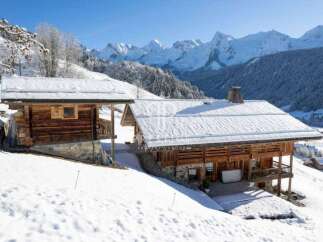 Experience the ultimate alpine escape in this stunning chalet nestled amidst a snowy landscape.