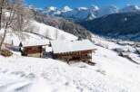 Discover a stunning chalet nestled in a picturesque snowy landscape.