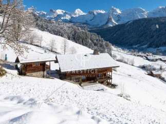 Discover a stunning chalet nestled in a picturesque snowy landscape.