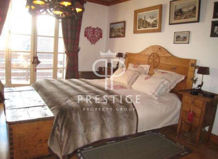 This charming bedroom boasts a rustic wooden headboard and a cozy, inviting atmosphere.