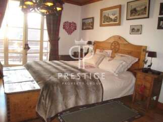 This charming bedroom boasts a rustic wooden headboard and a cozy, inviting atmosphere.