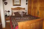 Cozy bedroom with a rustic wooden bed frame and headboard.