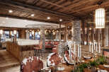 This stunning restaurant boasts a rustic-chic design with exposed wooden beams, stone pillars, and a cozy ambiance.
