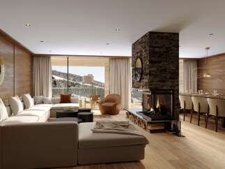 This luxurious chalet boasts an open-plan living area with a stunning fireplace as the centerpiece, creating a warm and inviting atmosphere.