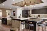 This stunning kitchen boasts a modern design with dark gray cabinetry, marble countertops, and a large island with seating.