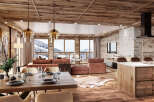 This stunning chalet boasts a spacious open-plan living area with floor-to-ceiling windows offering breathtaking mountain views.