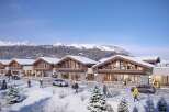 Discover luxurious chalets nestled in a breathtaking snowy mountain setting.