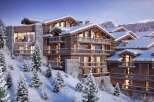 Luxury chalet apartments nestled in a snowy mountainside, offering breathtaking views and stunning architecture.