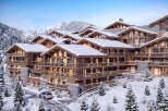 Luxury chalet-style apartments nestled in a stunning snowy mountain setting.