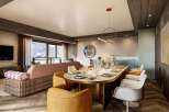 This luxurious apartment boasts a spacious open-plan living area with stunning mountain views, a chic dining setting perfect for entertaining, and a modern kitchen.