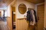 This cozy apartment boasts a charming wooden interior with a bunk bed tucked away in a hallway alcove.