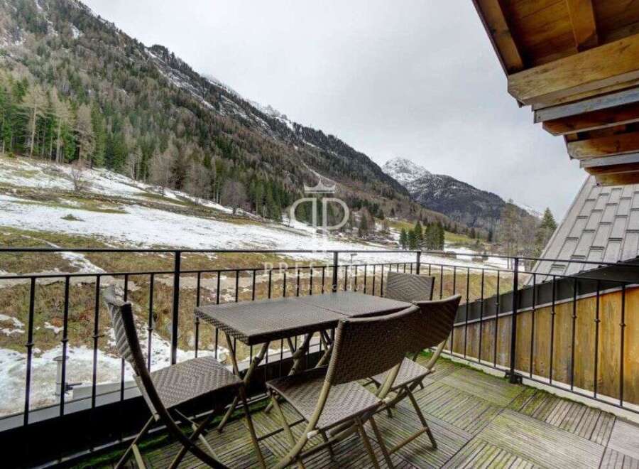 Enjoy breathtaking mountain views from this charming balcony.