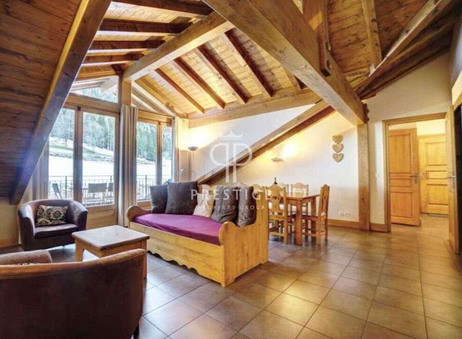 Discover the charm of this stunning property, featuring a cozy living area with a unique wooden ceiling design.