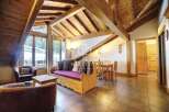 Discover the charm of this stunning property, featuring a cozy living area with a unique wooden ceiling design.