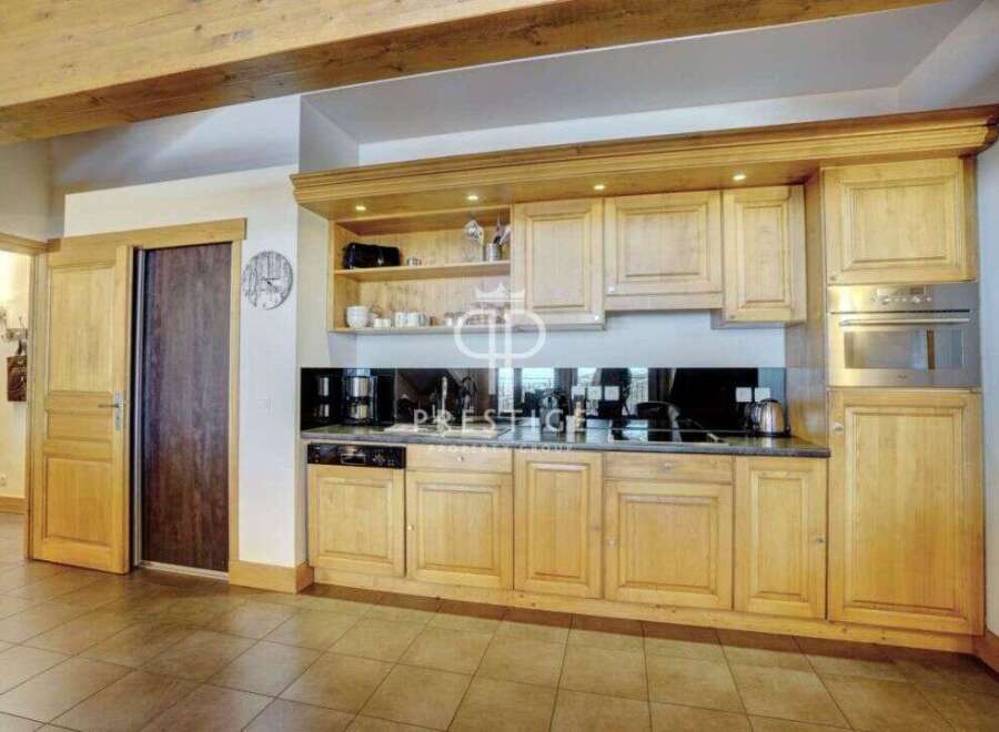 Discover a stunning kitchen with custom wooden cabinetry, perfect for culinary enthusiasts.
