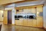 Discover a stunning kitchen with custom wooden cabinetry, perfect for culinary enthusiasts.