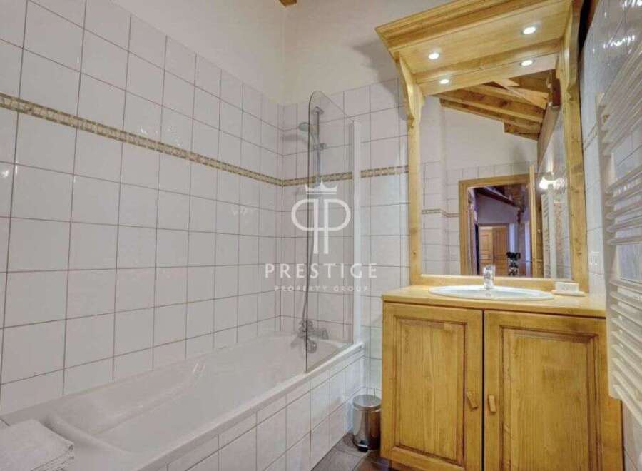 Discover a charming bathroom with a rustic wooden vanity and a large mirror.