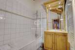 Discover a charming bathroom with a rustic wooden vanity and a large mirror.
