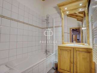 Discover a charming bathroom with a rustic wooden vanity and a large mirror.