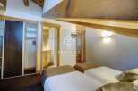 Discover the charm of this property, featuring a cozy bedroom with two beds.