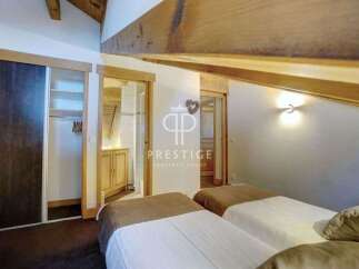 Discover the charm of this property, featuring a cozy bedroom with two beds.