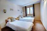 Discover a cozy bedroom featuring two comfortable beds, perfect for a relaxing stay.