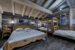 Experience rustic charm in this stunning bedroom featuring wooden accents and a cozy atmosphere.