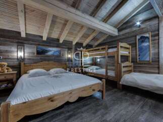 Experience rustic charm in this stunning bedroom featuring wooden accents and a cozy atmosphere.
