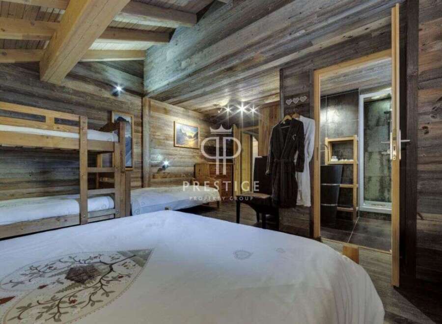 Experience rustic luxury in this stunning chalet bedroom.