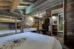 Experience rustic luxury in this stunning chalet bedroom.