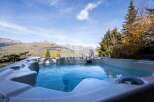 Indulge in luxury with this stunning property featuring a private hot tub.