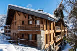 This stunning chalet boasts a unique architectural design, combining rustic wood with modern elements for a luxurious feel.