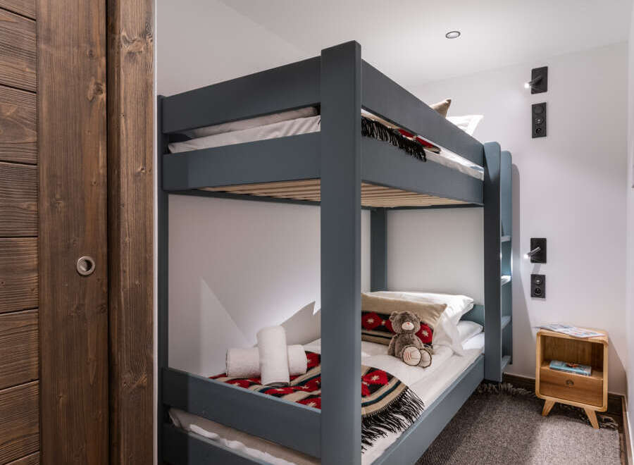 Cozy bunk beds in a charming chalet-style room, perfect for children.