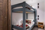 Cozy bunk beds in a charming chalet-style room, perfect for children.